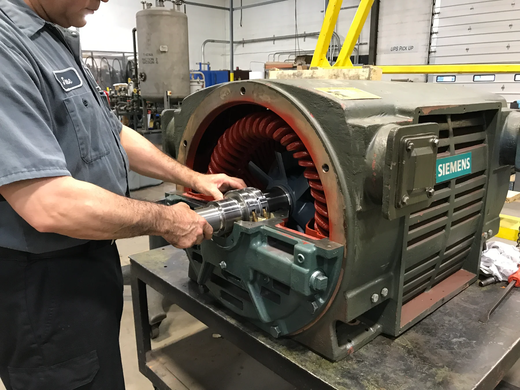 Technician working inside an open electric motor